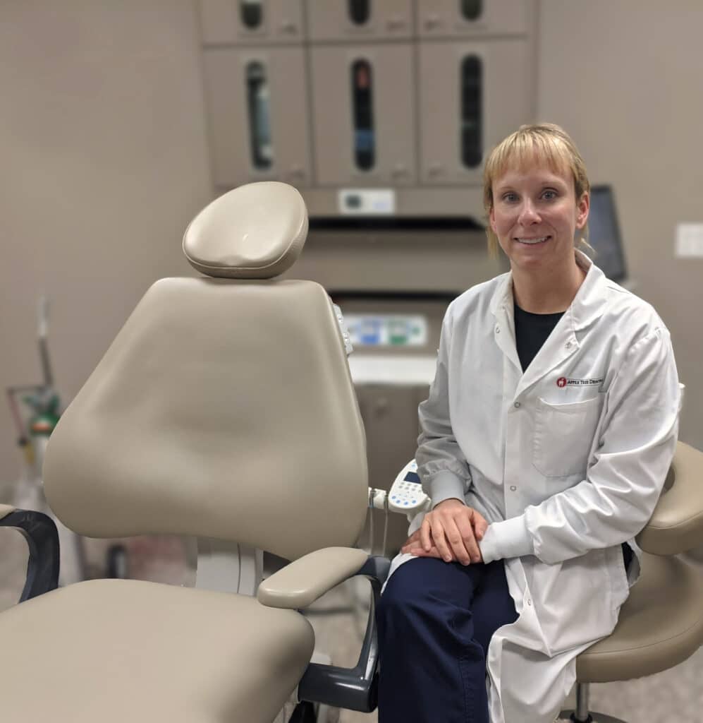 Heather Luebben pictured next to a dental chair